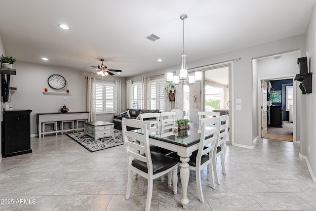 dining room featuring plenty of natural light and ceiling fan with notable chandelier