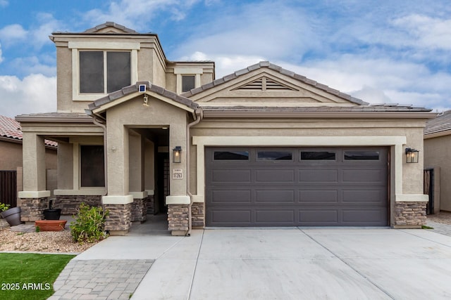 view of front of house featuring stone siding, stucco siding, driveway, and an attached garage