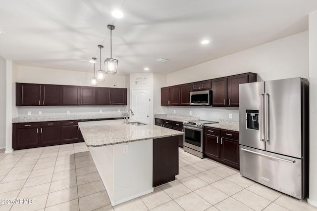 kitchen with light tile patterned flooring, dark brown cabinetry, appliances with stainless steel finishes, and a sink