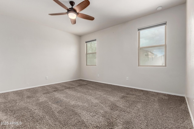 carpeted empty room with baseboards and ceiling fan