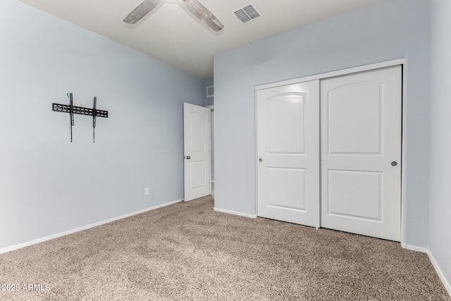 unfurnished bedroom featuring a closet, visible vents, baseboards, and carpet