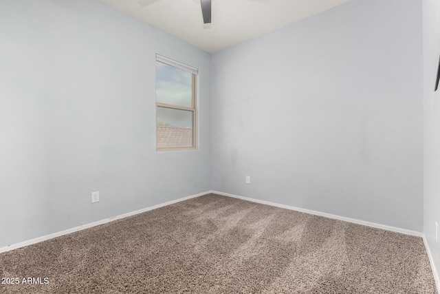 unfurnished room featuring a ceiling fan, carpet, and baseboards