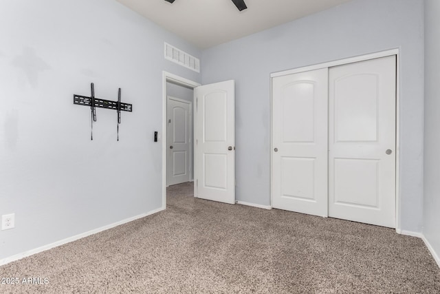 unfurnished bedroom with visible vents, baseboards, carpet, a closet, and a ceiling fan