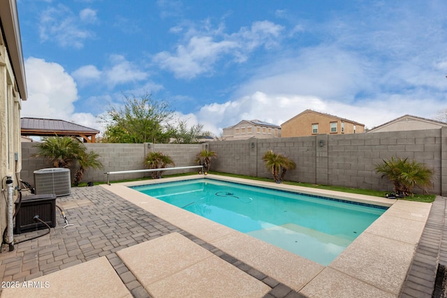 view of pool featuring cooling unit, a patio area, a fenced in pool, and a fenced backyard