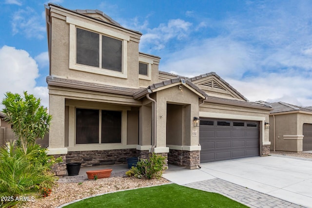 view of front facade with stucco siding, stone siding, driveway, and an attached garage