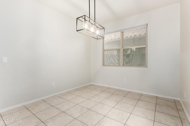 unfurnished dining area with baseboards