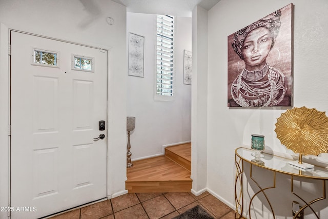 tiled entrance foyer featuring baseboards