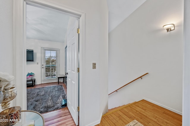 hall with baseboards and light wood-style flooring