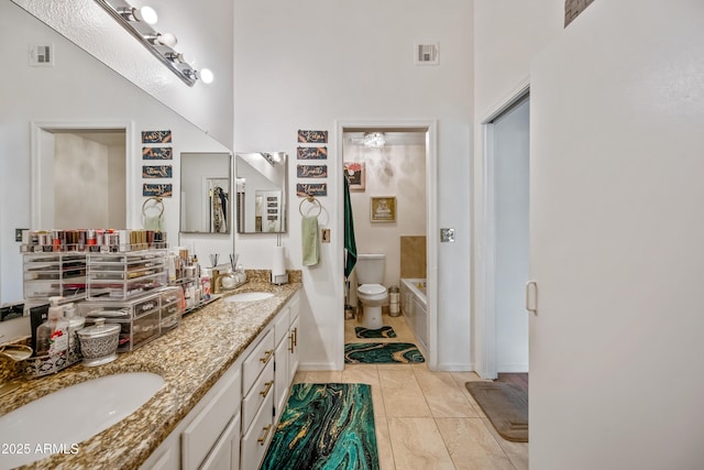 bathroom featuring double vanity, visible vents, and a sink