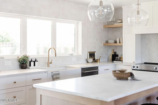 kitchen featuring white cabinetry, hanging light fixtures, tasteful backsplash, and sink