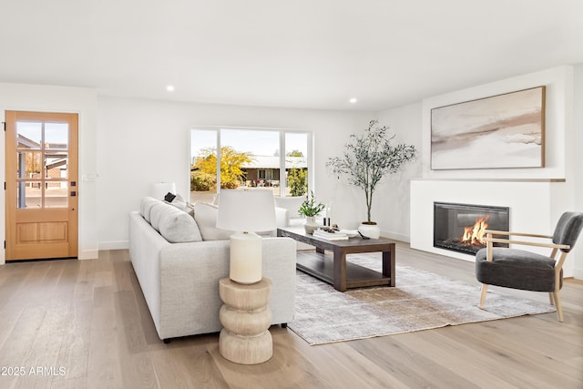 living room with a wealth of natural light and light hardwood / wood-style floors