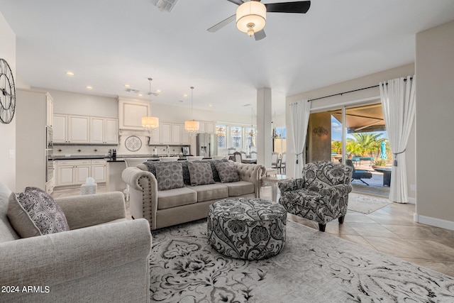 living room with ceiling fan and light tile patterned floors