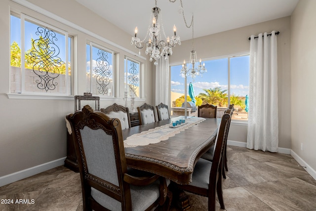 dining space with a wealth of natural light and a chandelier