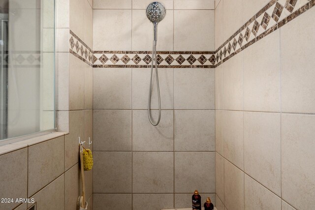 bathroom with ceiling fan with notable chandelier, built in features, and sink