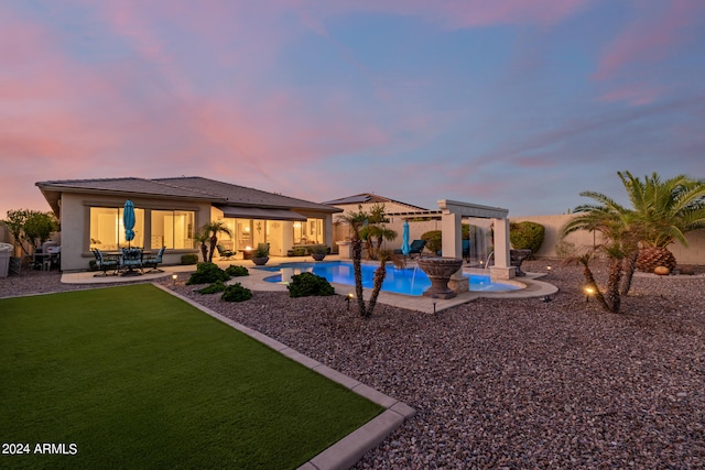 pool at dusk with a patio area