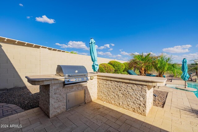 pool at dusk featuring a patio area