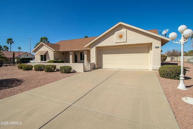 single story home with an attached garage, concrete driveway, and stucco siding