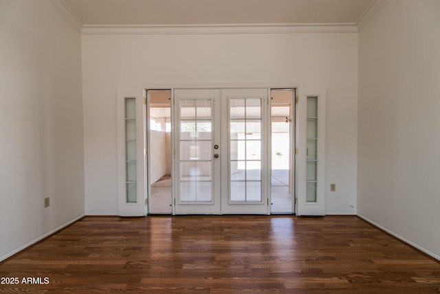 spare room with crown molding, wood finished floors, and french doors