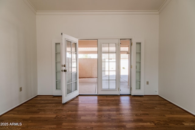 unfurnished room featuring ornamental molding, dark wood-style flooring, and baseboards