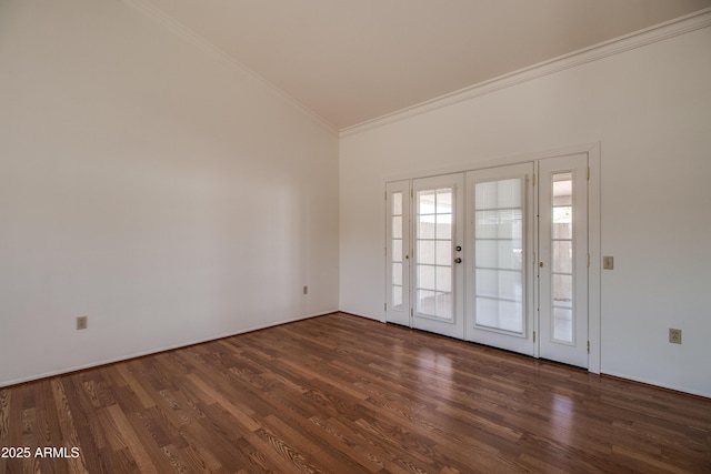 spare room with ornamental molding, wood finished floors, and french doors