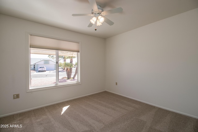 empty room featuring carpet flooring, a ceiling fan, and baseboards