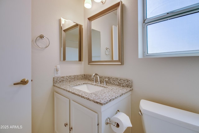 bathroom featuring toilet and vanity