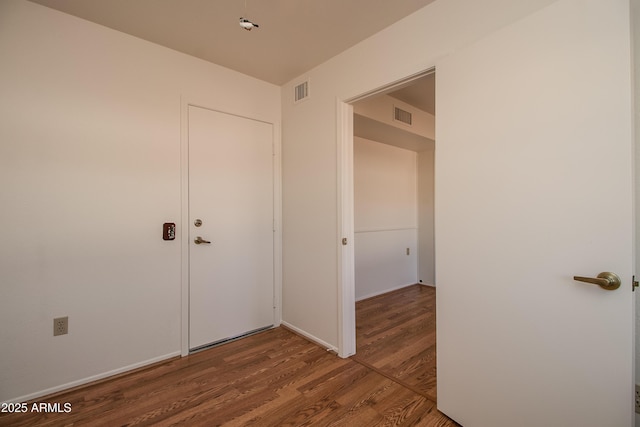 interior space featuring wood finished floors and visible vents