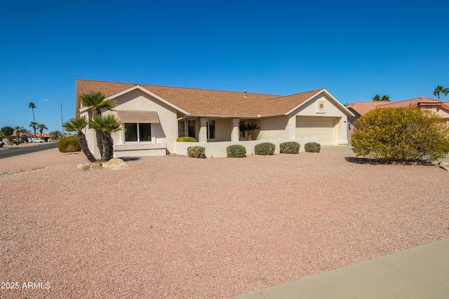 ranch-style house with a garage and stucco siding