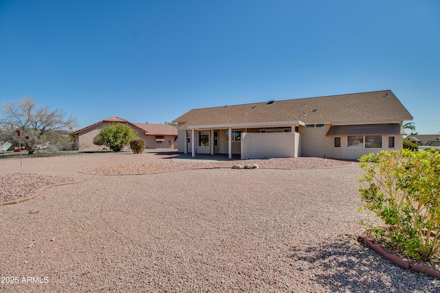 view of front of home featuring a patio and stucco siding