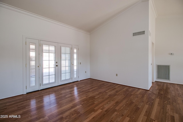 empty room with dark wood-type flooring, visible vents, and crown molding