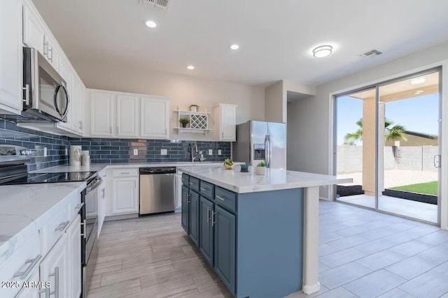 29891 N Desert Angel Dr, San Tan Valley, AZ 85143 - kitchen featuring stainless steel appliances, white cabinetry, tasteful backsplash, and recessed lighting