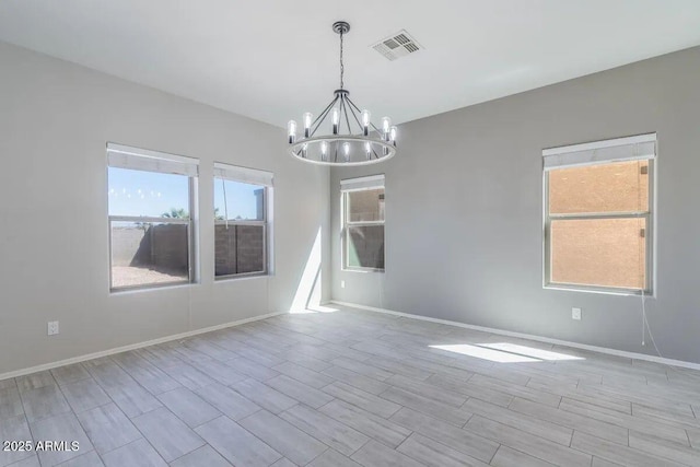 29891 N Desert Angel Dr, San Tan Valley, AZ 85143 - empty room with a chandelier, baseboards, and wood finish floors