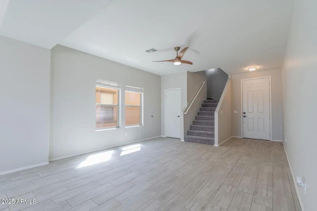 29891 N Desert Angel Dr, San Tan Valley, AZ 85143 - unfurnished living room with stairway, light wood-type flooring, ceiling fan, and baseboards