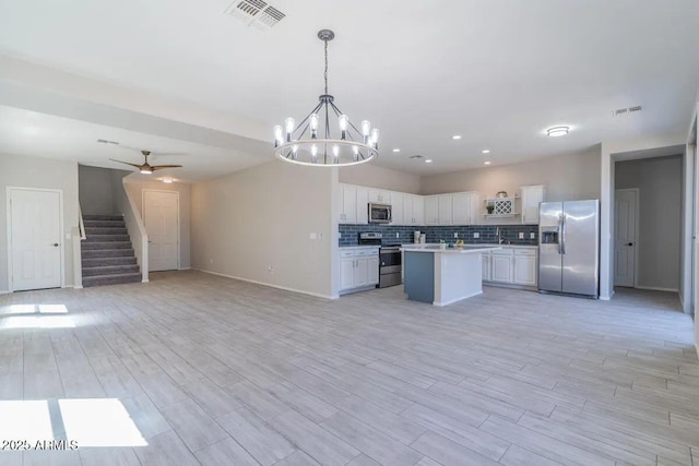 29891 N Desert Angel Dr, San Tan Valley, AZ 85143 - kitchen with stainless steel appliances, open floor plan, light countertops, white cabinetry, and a chandelier