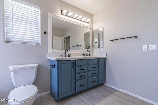 29891 N Desert Angel Dr, San Tan Valley, AZ 85143 - full bathroom with double vanity, wood finished floors, toilet, and baseboards