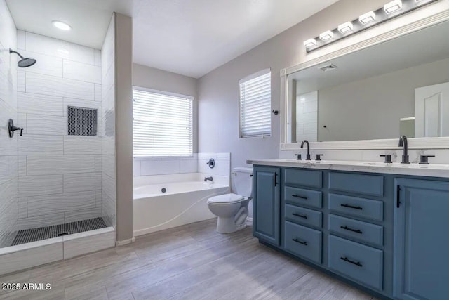 29891 N Desert Angel Dr, San Tan Valley, AZ 85143 - bathroom featuring double vanity, toilet, tiled shower, a garden tub, and wood finished floors