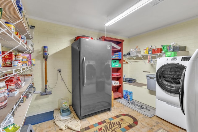 clothes washing area featuring washer / dryer and laundry area
