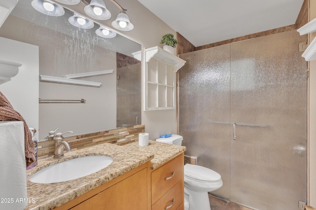 bathroom with vanity, toilet, tile patterned floors, and a stall shower