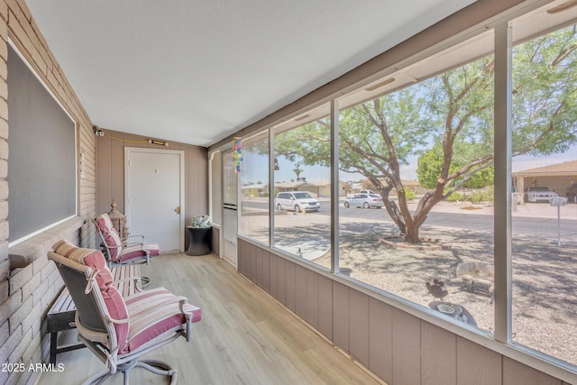 sunroom with wood walls and wood finished floors