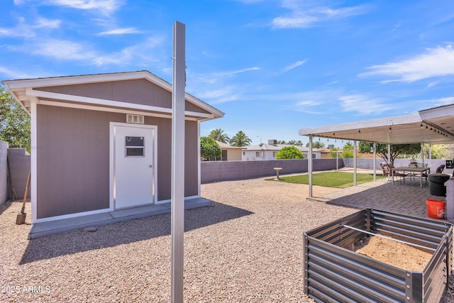 exterior space featuring a fenced backyard, an outdoor structure, and a shed