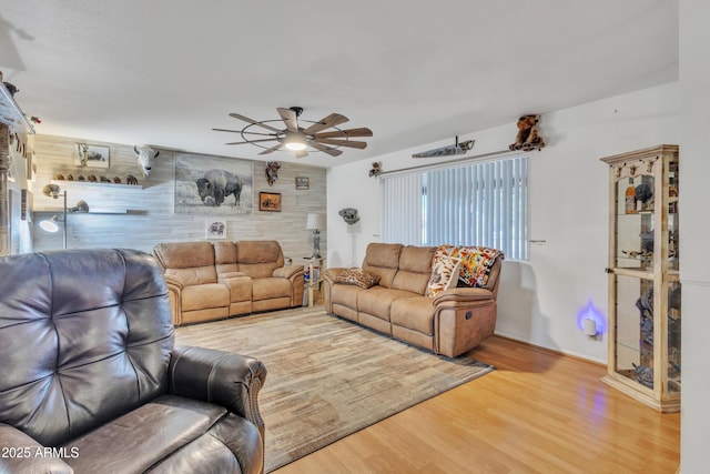 living room featuring ceiling fan and wood finished floors
