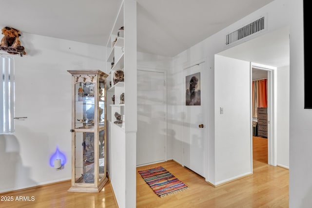 bathroom with visible vents, baseboards, and wood finished floors