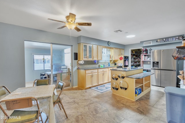 kitchen with open shelves, visible vents, stainless steel fridge with ice dispenser, and light brown cabinets