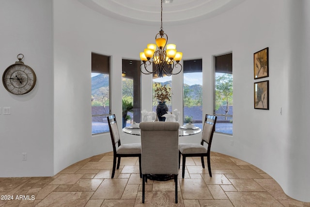 dining room featuring a notable chandelier and a tray ceiling