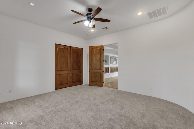 unfurnished bedroom with carpet flooring, a closet, and ceiling fan