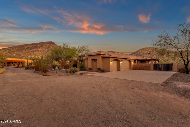 view of front facade featuring a mountain view and a garage