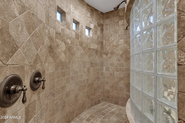 bathroom with a tile shower