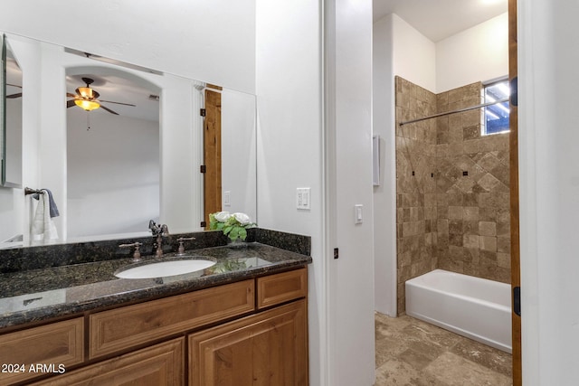 bathroom with vanity, tiled shower / bath, and ceiling fan