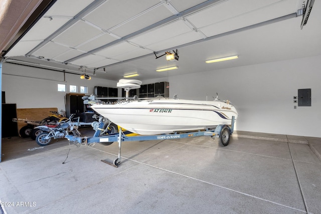 garage with electric panel and a garage door opener