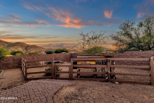 gate at dusk with a mountain view